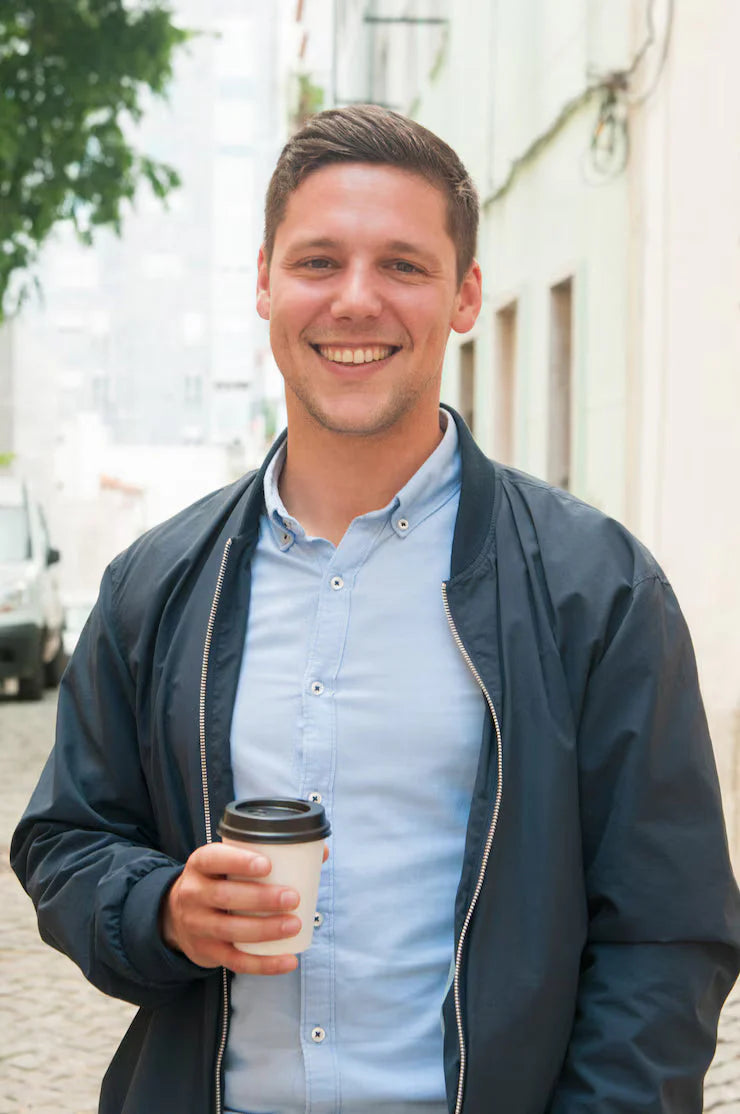 files/cheerful-guy-enjoying-outdoor-coffee-break_1262-20005.webp