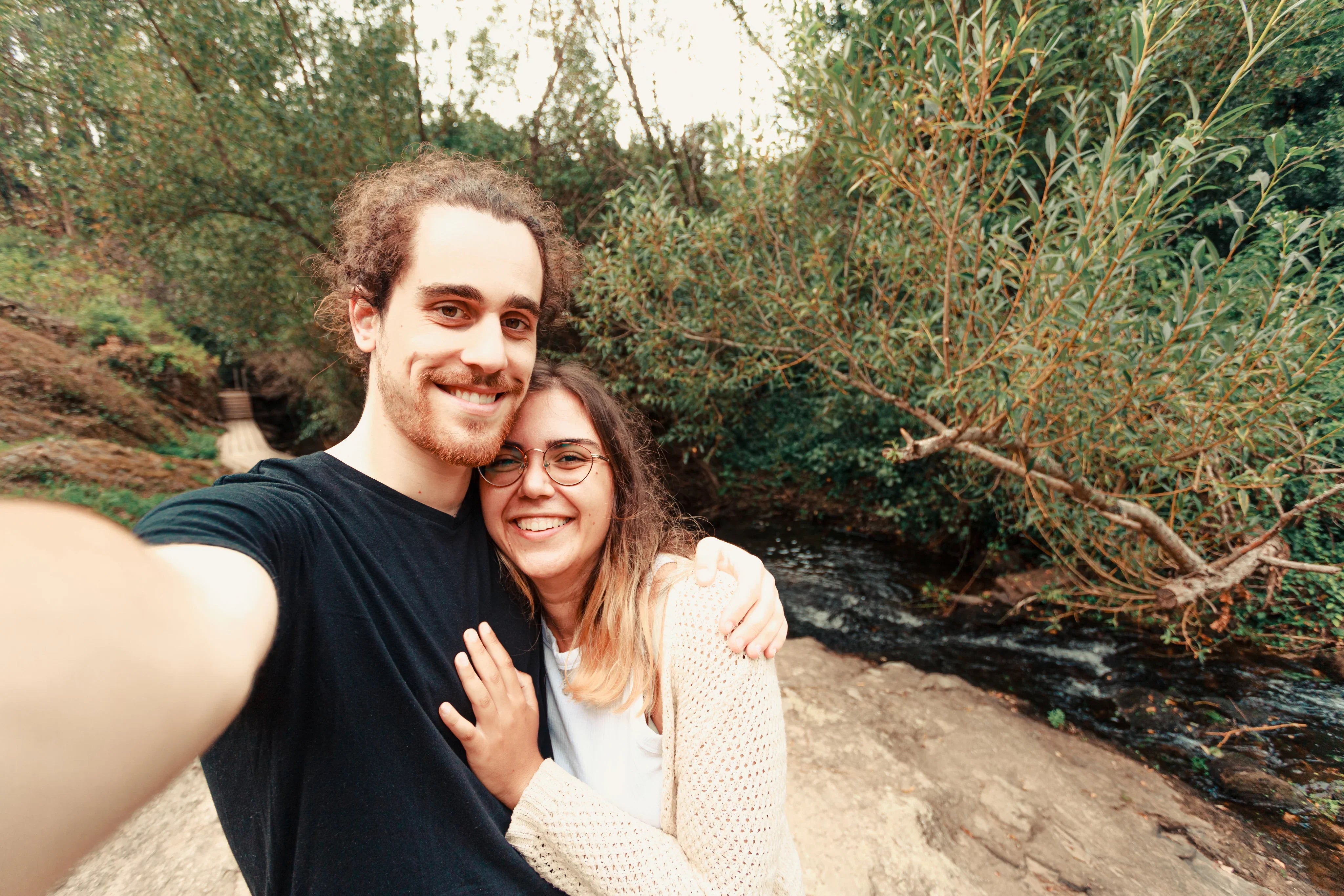 files/couple-stands-by-a-river-and-take-a-selfie_74c30c42-dc8f-4f1d-a88a-61a6e114950c.webp